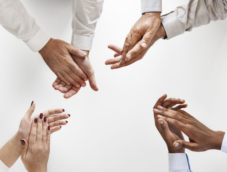 Business people clapping hands together